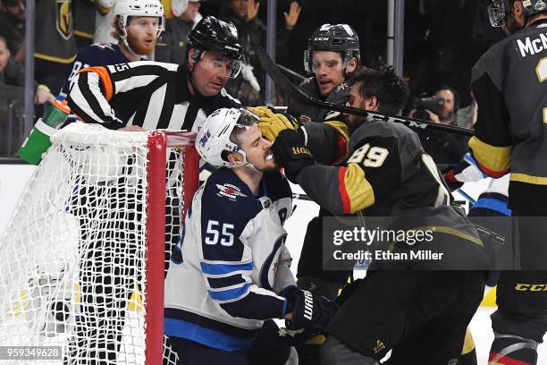Alex Tuch of the Vegas Golden Knights pushes Mark Scheifele of the Winnipeg Jets into the net during the third period of Game Three of the Western...
