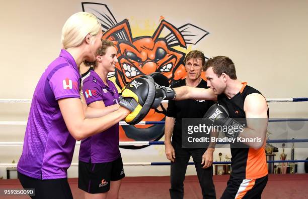 Jeff Horn trains with Queensland Firebirds players Gabi Simpson and Gretel Tippett bfeore a sparring session with Ray Robinson at Stretton Boxing...