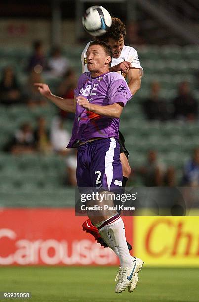 Daniel McBreen of the Glory is challenged by Jonathan McKain of the Phoenix during the round 24 A-League match between the Perth Glory and the...