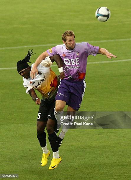 Andy Todd of the Glory and Eugene Dadi of the Phoenix contest the ball during the round 24 A-League match between the Perth Glory and the Wellington...