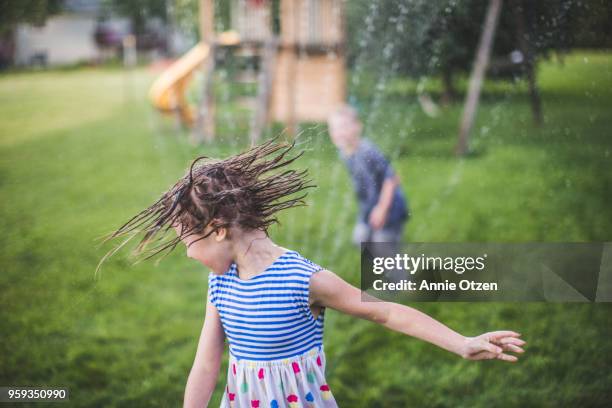 children playing in sprinkler - annie sprinkle stock pictures, royalty-free photos & images