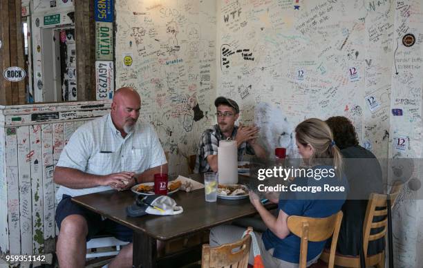 People enjoy inside seating at 12 Bones Smokehouse barbecue restaurant in the River Arts District on May 11, 2018 in Asheville, North Carolina....