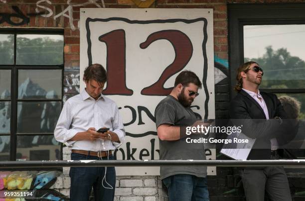 People stand in line at 12 Bones Smokehouse barbecue restaurant in the River Arts District on May 11, 2018 in Asheville, North Carolina. Located in...