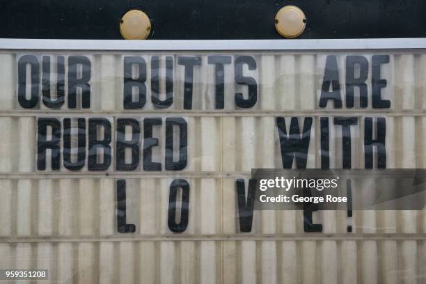 Humorous billboard at 12 Bones Smokehouse barbecue restaurant in the River Arts District is viewed on May 11, 2018 in Asheville, North Carolina....