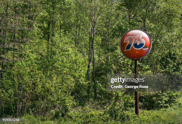 Distinctive Union Oil 76 orange ball logo stands in a lush, green forest where a gas staton once stood on May 11, 2018 near Asheville, North...