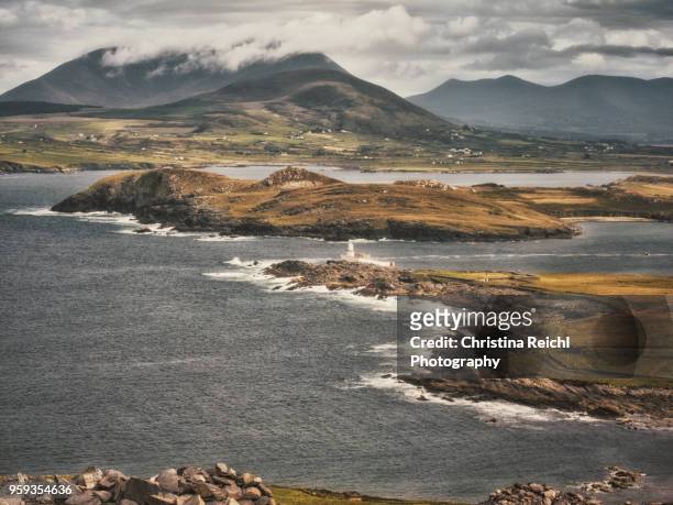 rough irish coast and landscape with lighthouse - christina rau stock-fotos und bilder