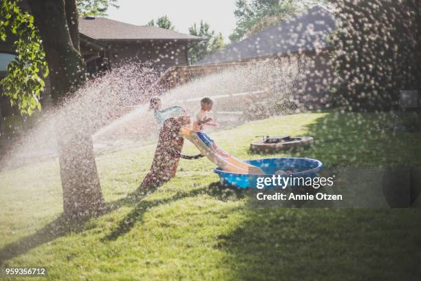 summer kids playing in backyard - annie sprinkle stock pictures, royalty-free photos & images