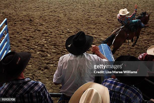 Cowboys sit near the shoots to watch the bronc riders during the ABCRA National Rodeo Finals on January 22, 2010 in Tamworth, Australia. The National...