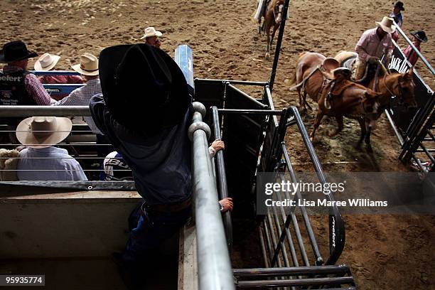 Young cowboy stands near the shoots to watch the bronc riders during the ABCRA National Rodeo Finals on January 22, 2010 in Tamworth, Australia. The...