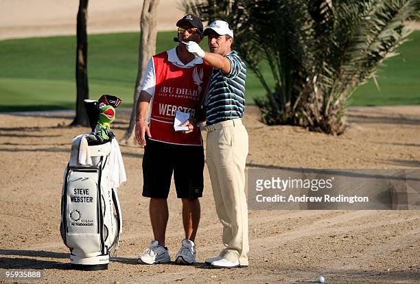 Steve Webster of England talks with his caddie on the eighth hole during the second round of The Abu Dhabi Golf Championship at Abu Dhabi Golf Club...