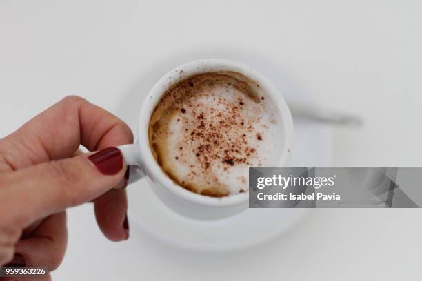 above view of woman hand taking fresh coffee - isabel pavia stock-fotos und bilder