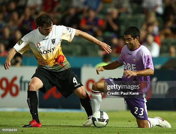 Jonathan McKain of the Phoenix and Andrija Jukic of the Glory contest the ball during the round 24 A-League match between the Perth Glory and the...