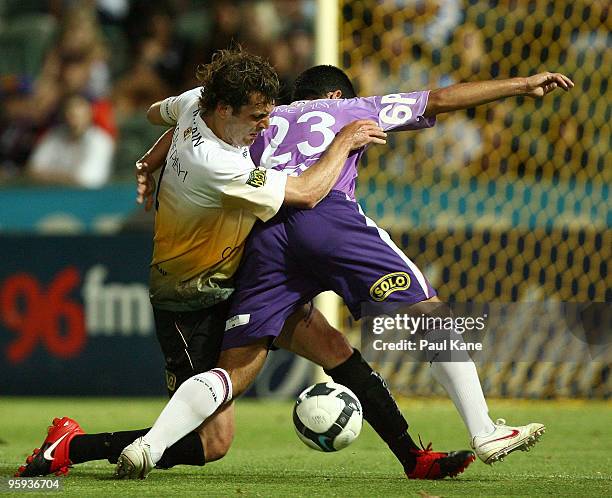 Jonathan McKain of the Phoenix and Andrija Jukic of the Glory contest the ball during the round 24 A-League match between the Perth Glory and the...