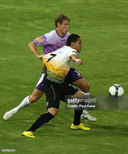 Jamie Coyne of the Glory challenges Leo Bertos of the Phoenix during the round 24 A-League match between the Perth Glory and the Wellington Phoenix...