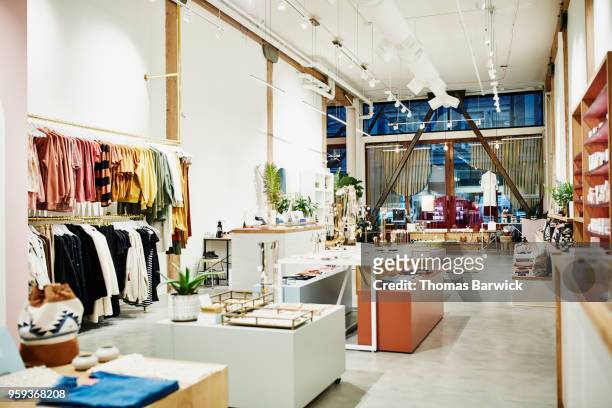 interior of clothing boutique - negozio foto e immagini stock