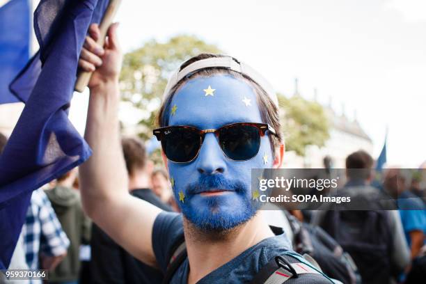 Man with his face made up as the EU flag strikes a pose at a rally in Parliament Square at the end of the pro-EU "March for Europe", tens of...