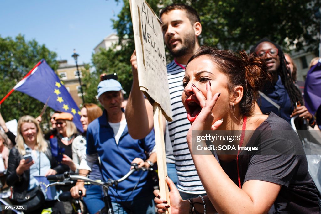 A demonstrator on Whitehall shouts towards Downing Street...