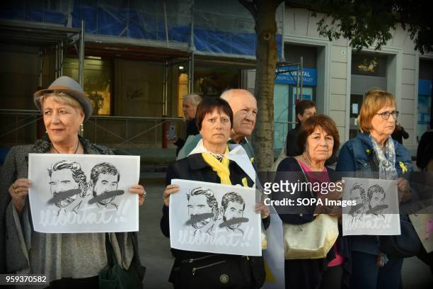 Protesters seen holding placards during the demonstration. Around fifty people gathered in L'Hospitalet City to demand the release of the political...