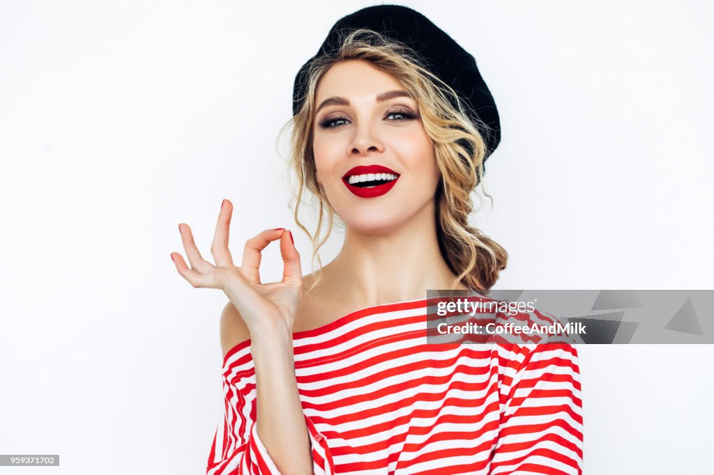 Beautiful blonde french woman wearing red beret