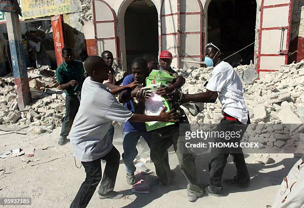 Looters fight among themselves as loot from a earthquake destroyed stores on January 21, 2010 in Port-au-Prince, Haiti. Not knowing where to turn,...
