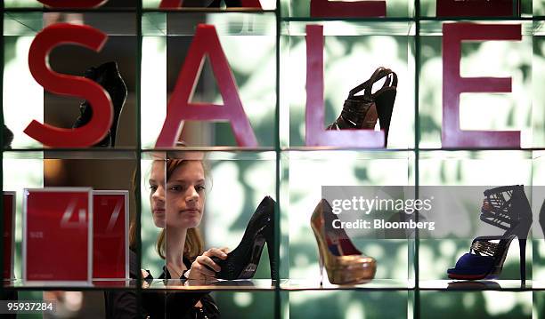 Katie Barnard browses sale items on display at a shoe store at the Bluewater Shopping & Leisure Centre near Greenhithe, U.K., on Thursday, Jan. 21,...