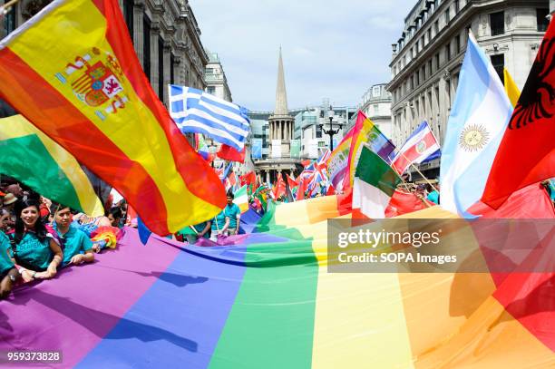 Giant rainbow flag is carried along Regent Street as the 2017 Pride in London Parade through the West End gets underway. The event marked 50 years...