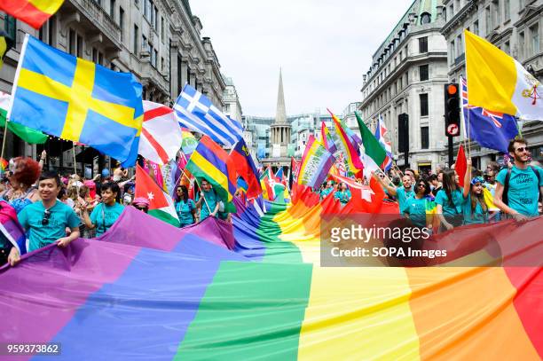 Giant rainbow flag is carried along Regent Street as the 2017 Pride in London Parade through the West End gets underway. The event marked 50 years...