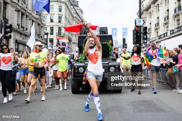 Marcher representing London sexual health clinic 56 Dean Street carries a flag along Regent Street during the 2017 Pride in London Parade through the...