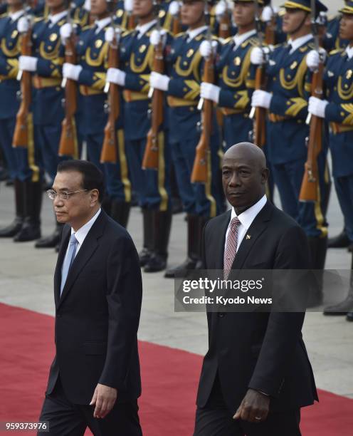 Trinidad and Tobago Prime Minister Keith Rowley inspects a guard of honor at a welcome ceremony with Chinese Premier Li Keqiang at the Great Hall of...
