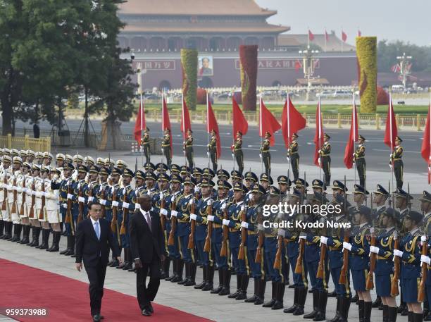 Trinidad and Tobago Prime Minister Keith Rowley inspects a guard of honor at a welcome ceremony with Chinese Premier Li Keqiang at the Great Hall of...