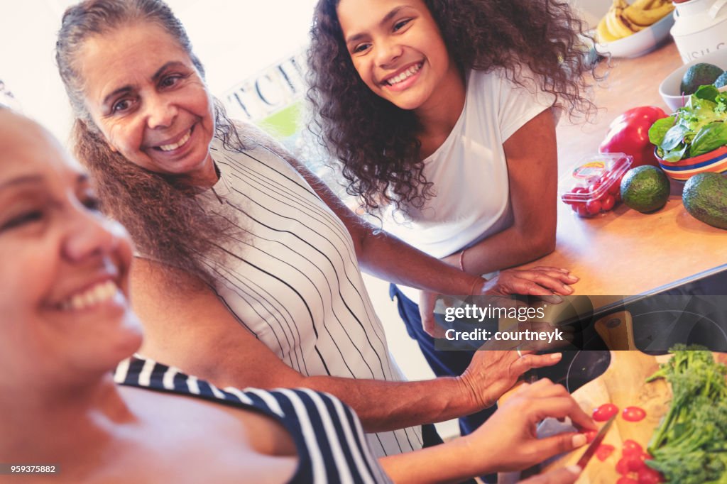 Grandmother, Mother and child cooking in the kitchen.