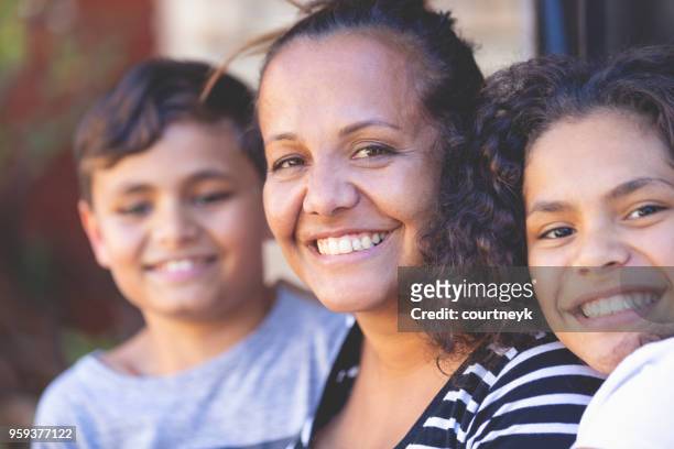 aboriginal family portrait with 1 parent and 2 children. - ethnicity stock pictures, royalty-free photos & images