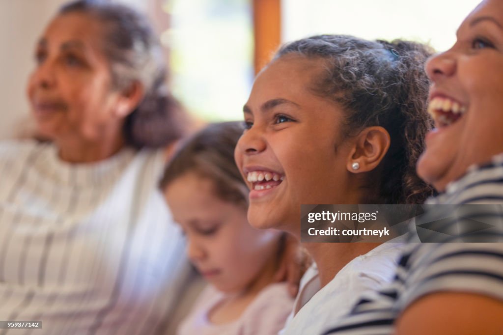 Multi generational women on the sofa. The young girls are sisters.