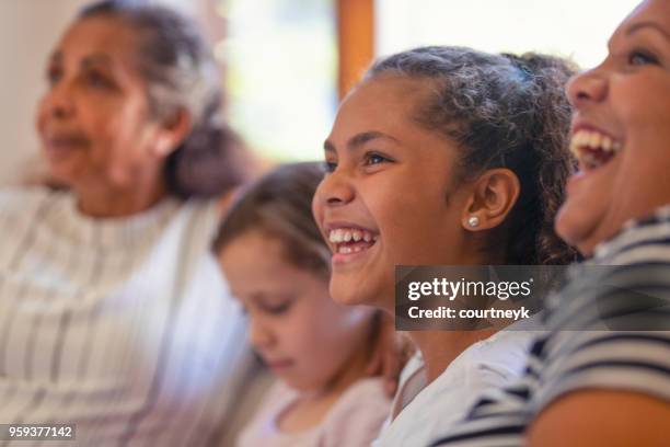 multi generational women on the sofa. the young girls are sisters. - regional new south wales stock pictures, royalty-free photos & images
