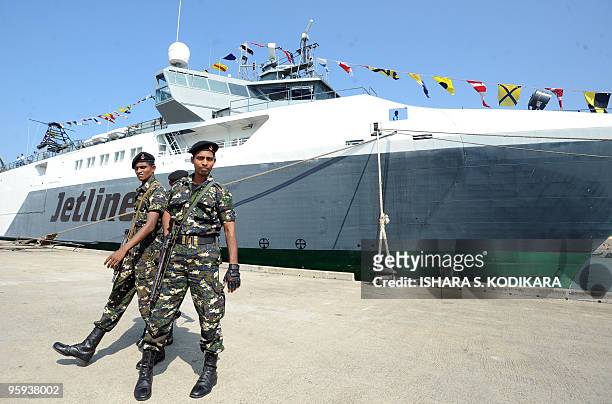 Sri Lankan special forces commandos stand guard during a floating naval vessel launch at the Colombo port on January 22, 2010. Known as the Jetliner,...