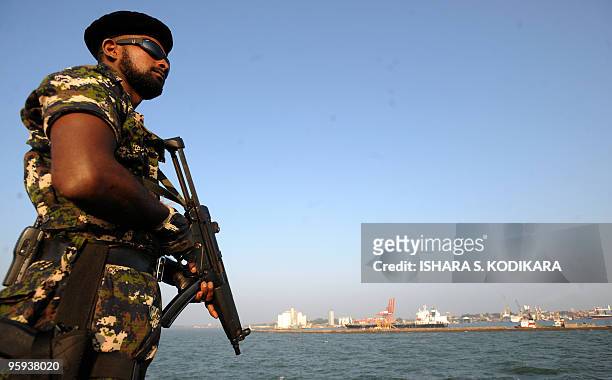 Sri Lankan special forces commando stands guard during a floating naval vessel launch at the Colombo port on January 22, 2010. Known as the Jetliner,...