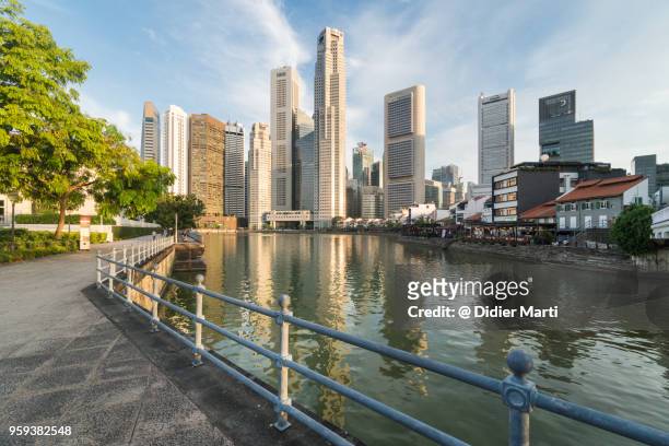 clark quay and the financial district skyline in singapore on a sunny day - singapore imagens e fotografias de stock
