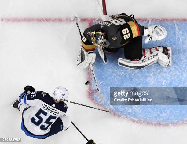 Mark Scheifele of the Winnipeg Jets tries to get a rebound against Marc-Andre Fleury of the Vegas Golden Knights in the second period of Game Three...