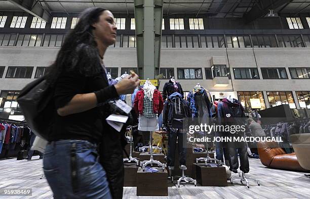 Visitor walks past a clothing display at the Bread and Butter international trade fair for street and urban wear at Berlin's Tempelhof airport...