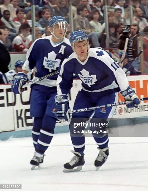 Vincent Damphousse and Borje Salming of the Toronto Maple Leafs skate against the Detroit Red Wings during NHL game action on March 24, 1989 at Joe...