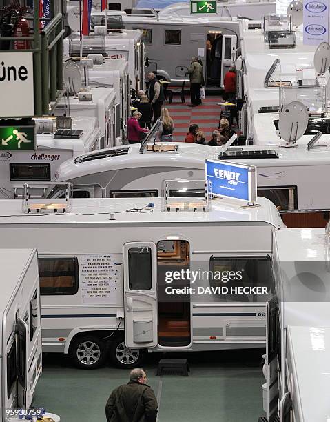 Visitors look at caravans and campervans during the "Caravan Freizeit Reisen" trade fair in Oldenburg, northern Germany on January 22, 2010. The...