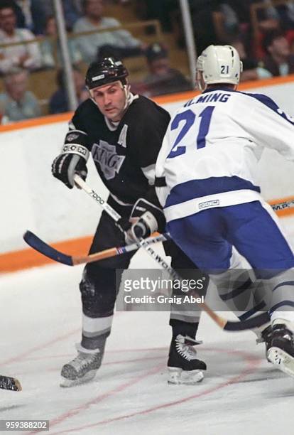 John Tonelli of the Los Angeles Kings skates against Borje Salming of the Toronto Maple Leafs during NHL game action on November 5, 1988 at Maple...