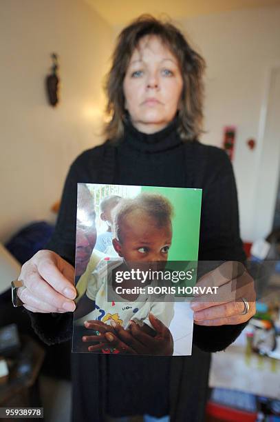 Attendant MICKENSON BLOQUE A PORT-AU-PRINCE" - French national Christine Bah shows a picture of Mickenson, a young Haitian in the process of...