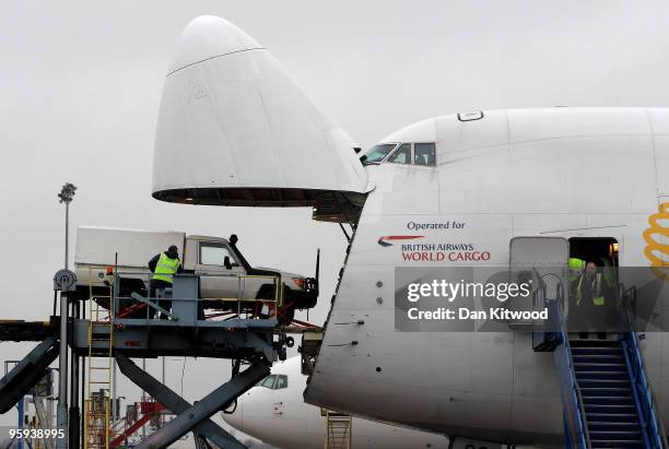 Consignment of aid from Oxfam's logistics warehouse in Oxfordshire, including two Toyota 4x4 vehicles is loaded onto a British Airways flight bound...