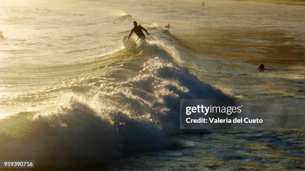 surfing at the top of the wave - valeria del cueto stock pictures, royalty-free photos & images