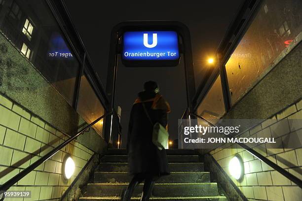 Woman walks out of the U6 underground station at the Oranienburger Tor station in Berlin January 13, 2010. AFP PHOTO / JOHN MACDOUGALL