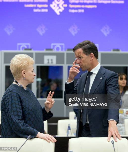 Lithuanian President Dalia Grybauskaite , speaks with Dutch Prime Minister Mark Rutte during a round table meeting of EU and Western Balkan heads of...