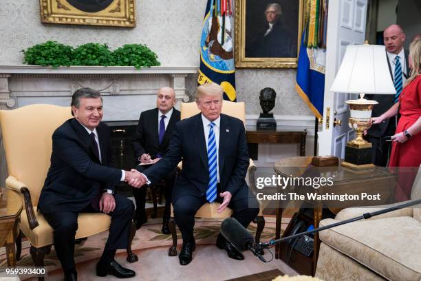 President Donald J. Trump shakes hands with President of the Republic of Uzbekistan Shavkat Mirziyoyev during a meeting in the Oval Office at the...