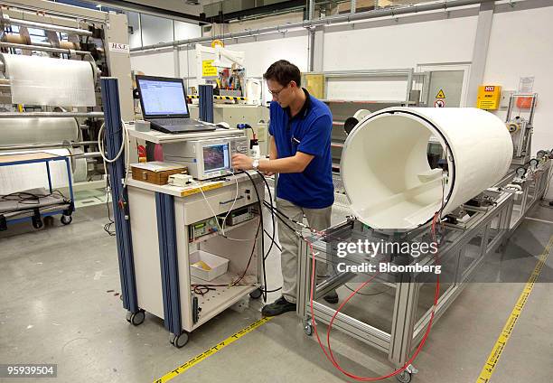 Siemens AG Healthcare employee tests the body coil of a Magnetic Resonance Imaging scanner at the company's factory in Erlangen, Germany, on...