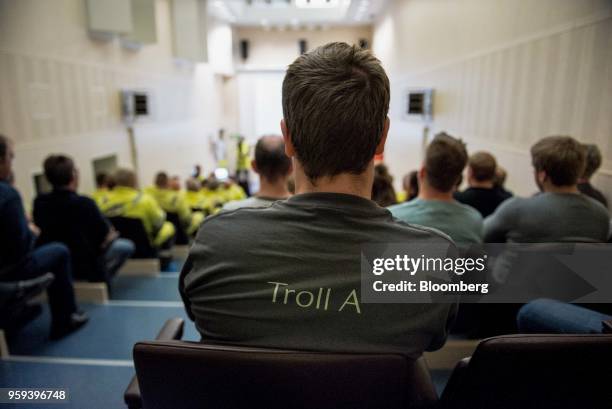 An employee wearing a t-shirt with "Troll A" written on the back listens to a briefting on board the Troll A natural gas platform, operated by...